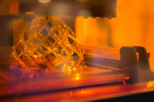 A stereolithography 3D printer creating a model
